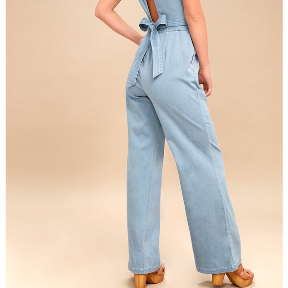 Light denim jumpsuit with a flattering tie waist.